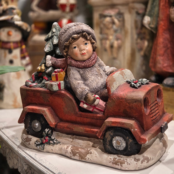 19 inch vintage style boy in a red truck with a Christmas tree and colorful gifts on a snowy base, hand painted polyresin