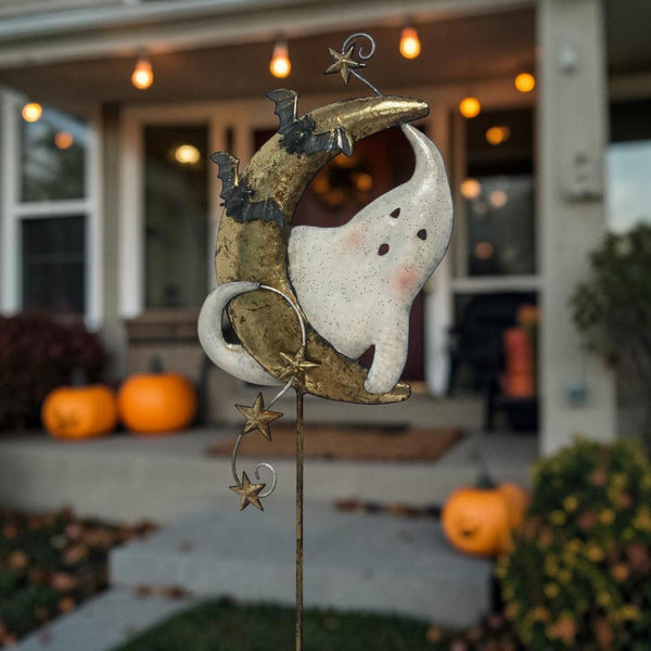 Hand painted iron garden stake with a white ghost sitting on a gold crescent moon