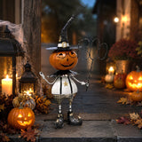 Hand painted iron jack-o-lantern figurine holding a wire BOO sign, orange, black, and white with glitter