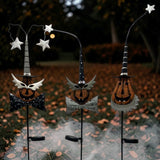Three hand painted iron solar jack-o-lantern garden stakes with a bow tie, batwings, and a witch hat