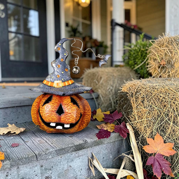 15.75 inch hand painted iron jack-o-lantern wearing an oversized witch hat with a silver bell and bats, orange