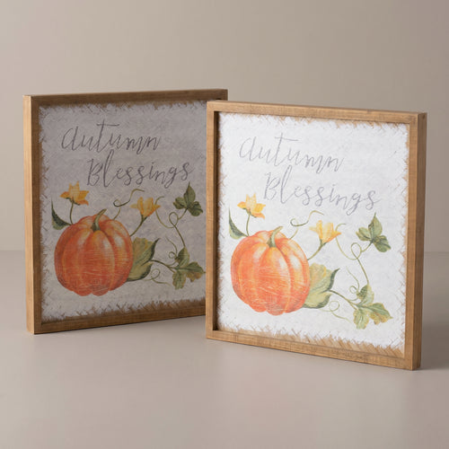 Two square fir wood and mdf signs with watercolor pumpkins and autumn blessings script, raised studio angle on a plain surface