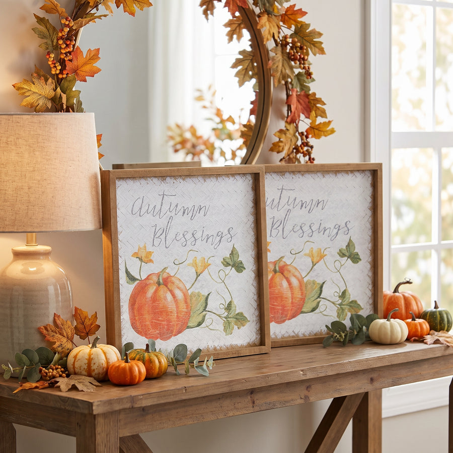 Two autumn blessing pumpkin signs propped on a console in a warm fall entryway