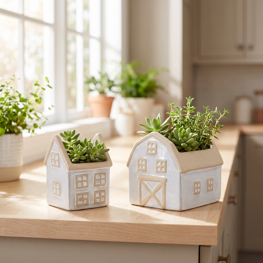 Set of two farmhouse house and barn planters with greenery on a sunny kitchen windowsill