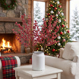 Frosted red berry Christmas sprays in a white crock in a cozy woodland cabin living room
