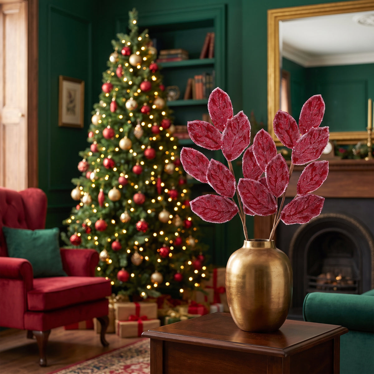 Crimson magnolia leaf Christmas sprays in a gold vase in an emerald green traditional living room