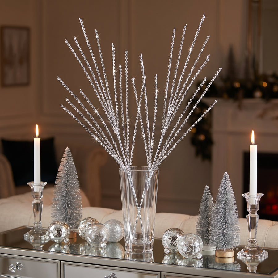 Silver bead strand sprays in a crystal vase on a mirrored Christmas console