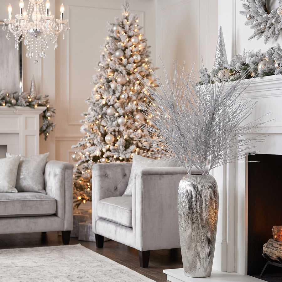 Silver glitter long needle pine Christmas sprays in a silver urn in a glam white living room