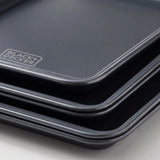 Close-up of the rolled rim and ceramic nonstick surface of a BLACK+DECKER carbon steel baking sheet