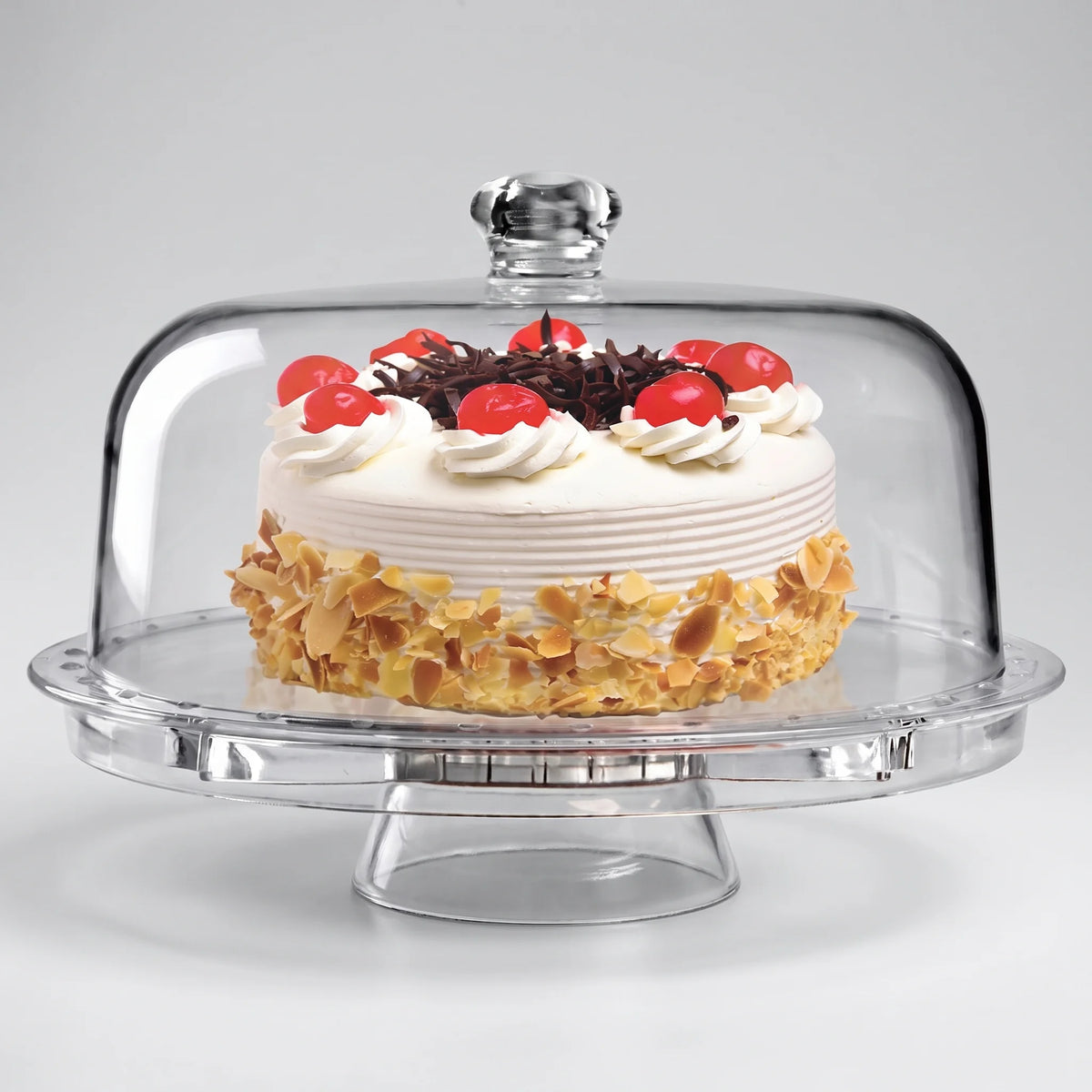 Fridgemate crystal clear acrylic cake stand with domed cover over a layer cake on a studio surface
