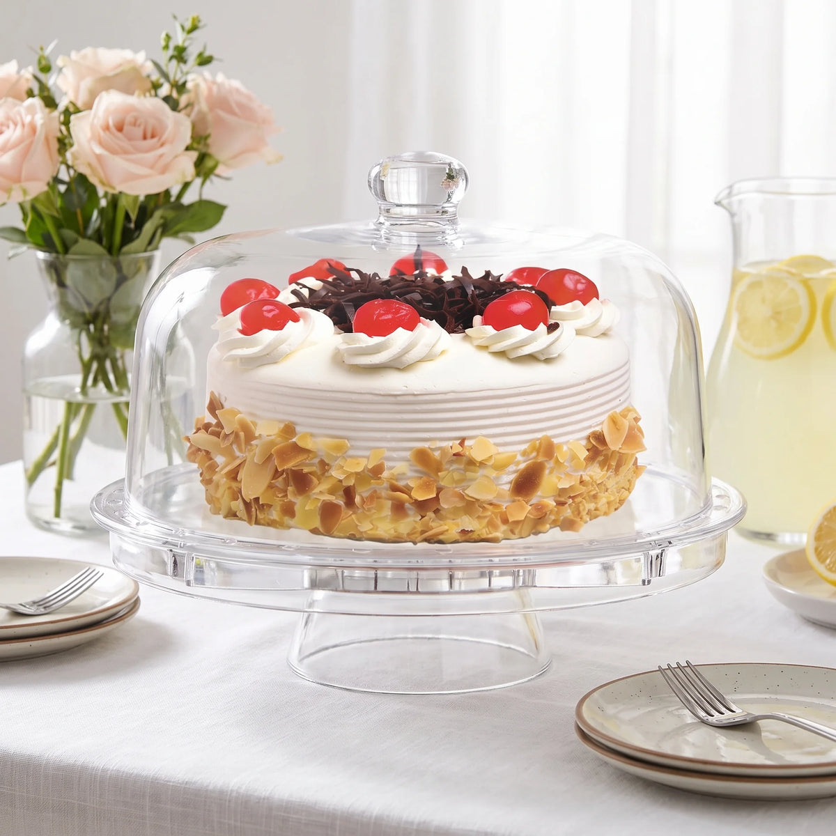Fridgemate crystal clear acrylic cake stand with dome on a brunch table with roses and lemonade