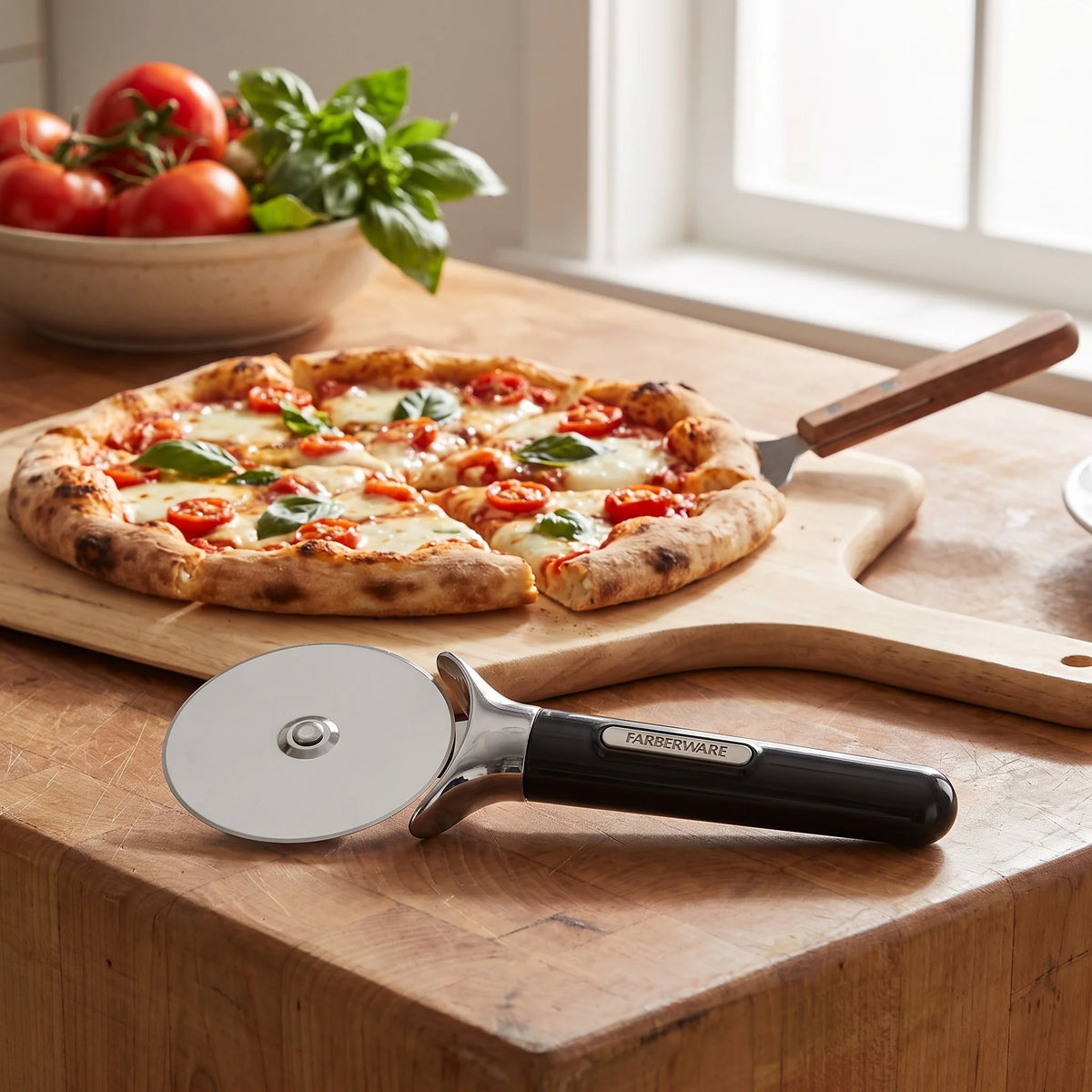 Farberware professional pizza cutter on a kitchen island beside a sliced homemade pizza