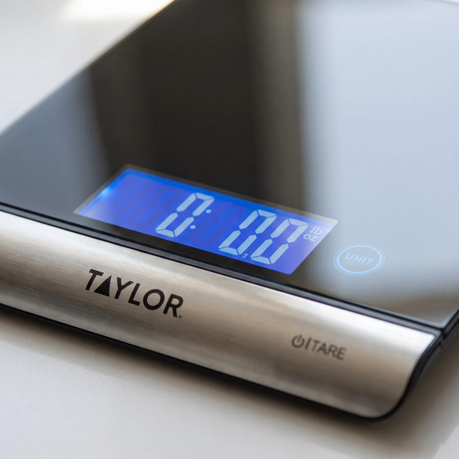 Close-up of the blue backlit display and touch controls on a Taylor 3851 digital kitchen scale