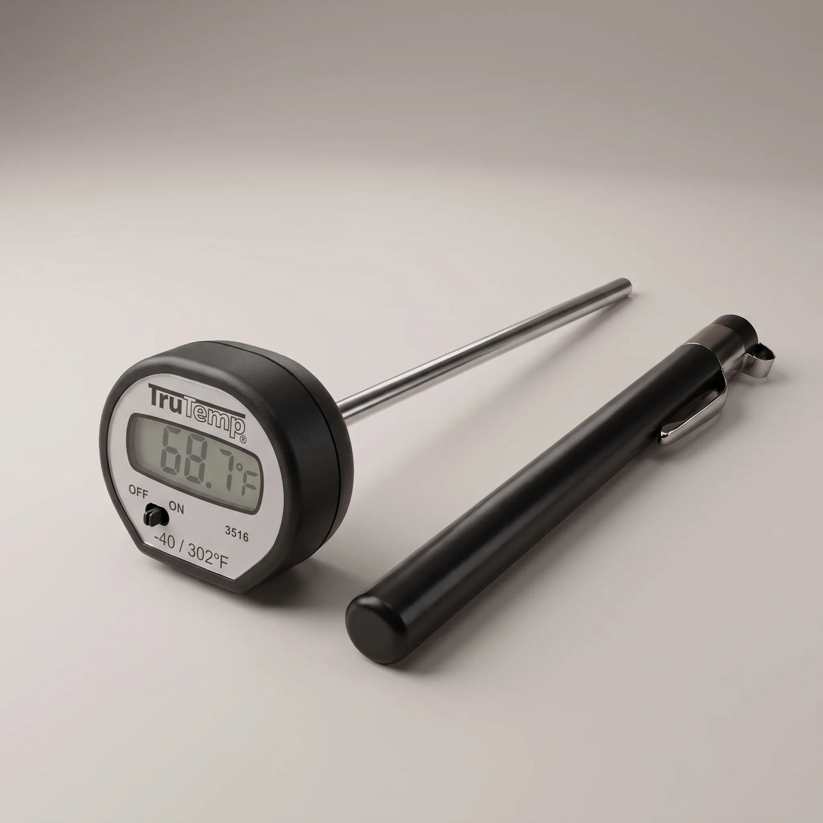 Taylor 3516 digital instant read pocket thermometer with LCD display, stainless steel stem and black pocket sleeve on a studio surface