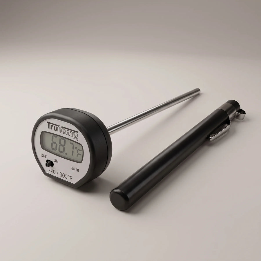 Taylor 3516 digital instant read pocket thermometer with LCD display, stainless steel stem and black pocket sleeve on a studio surface