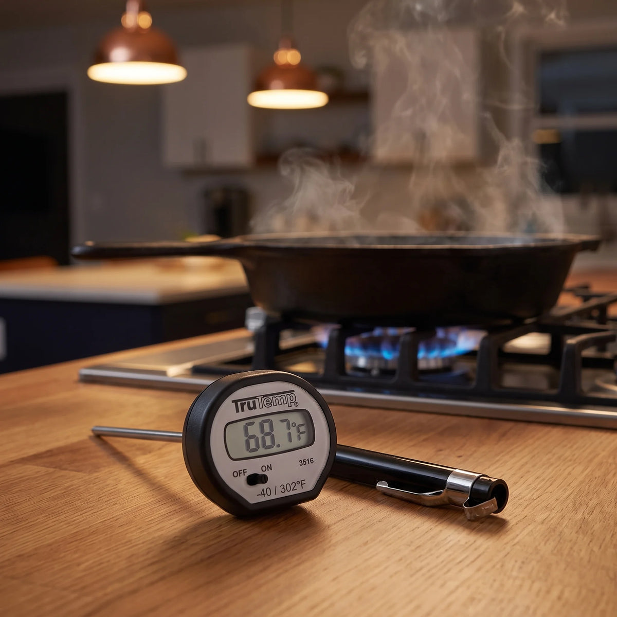 Taylor digital instant read thermometer on a kitchen counter beside the range for checking steak doneness