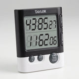 Taylor dual event digital kitchen timer with two large LCD readouts and Timer 1 and Timer 2 buttons on a studio surface