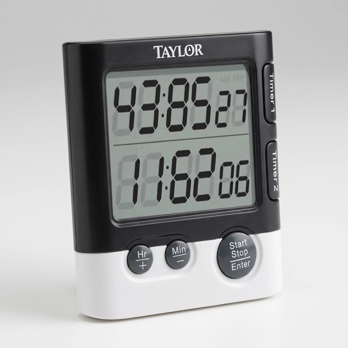 Taylor dual event digital kitchen timer with two large LCD readouts and Timer 1 and Timer 2 buttons on a studio surface