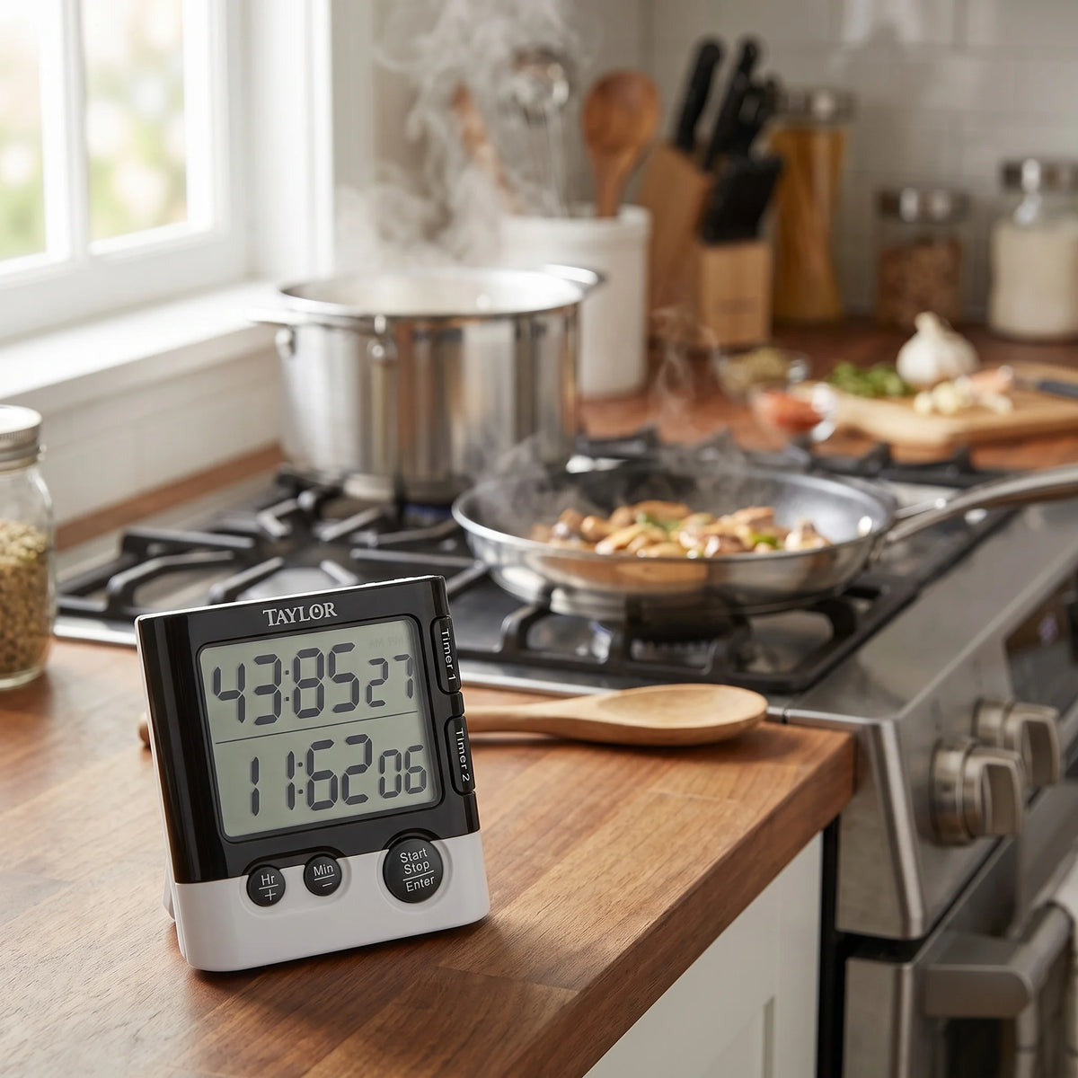 Taylor dual event digital timer on a kitchen counter beside the stove for timing two dishes at once