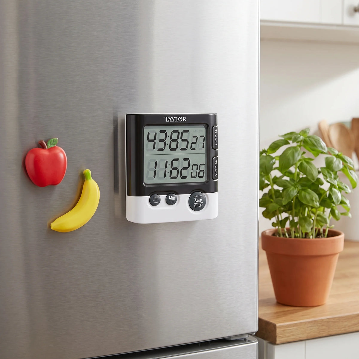 Taylor dual event digital timer magnetically attached to a stainless steel refrigerator door