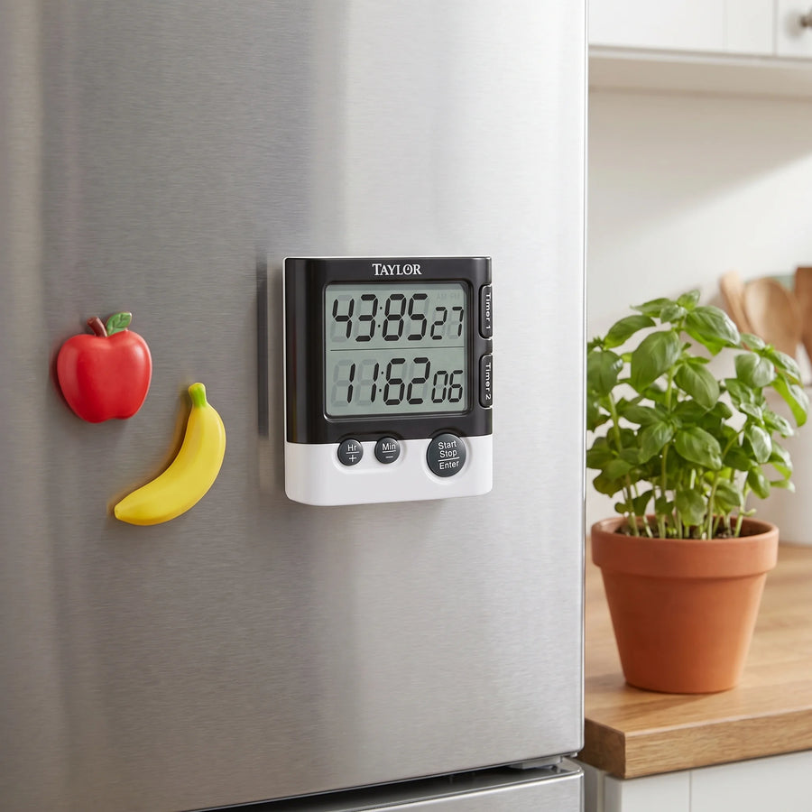 Taylor dual event digital timer magnetically attached to a stainless steel refrigerator door