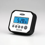 Taylor splash and drop water resistant digital kitchen timer with blue backlit LCD and black rubber bumper on a studio surface