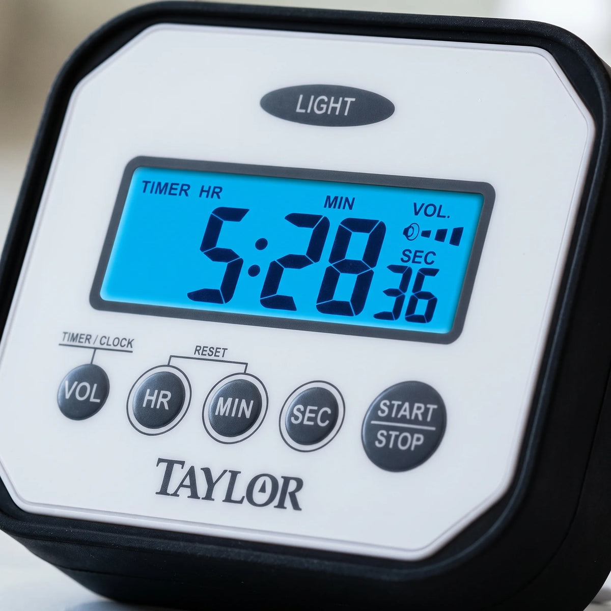 Close-up of the blue backlit LCD, buttons and rubber bumper on a Taylor splash and drop water resistant timer