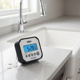 Taylor splash and drop IP65 water resistant timer on a kitchen counter beside a farmhouse sink