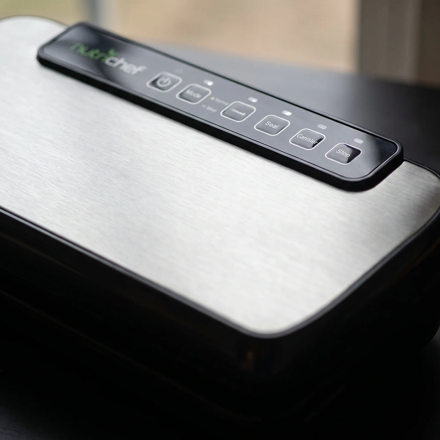 Close-up of the brushed stainless steel lid and touch control buttons of a NutriChef automatic vacuum sealer