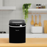 Black Magic Chef portable countertop ice maker on a kitchen counter with wooden utensils behind it