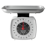 Taylor 3880 white analog kitchen scale with stainless steel tray, straight-on view of the 22 lb dial