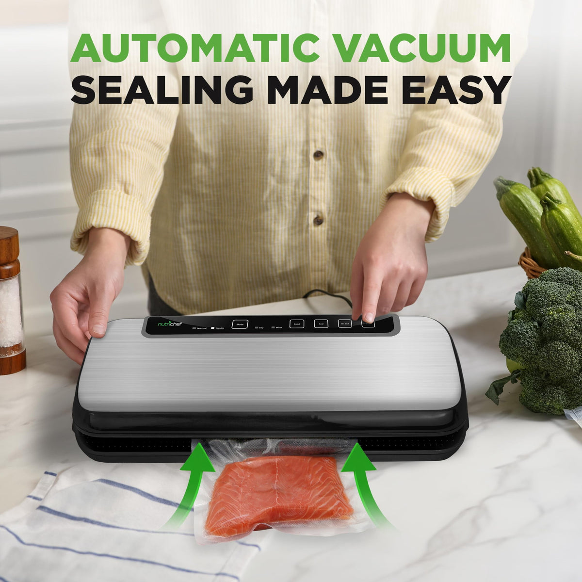 Hands placing a bag in the NutriChef stainless steel vacuum sealer on a kitchen counter