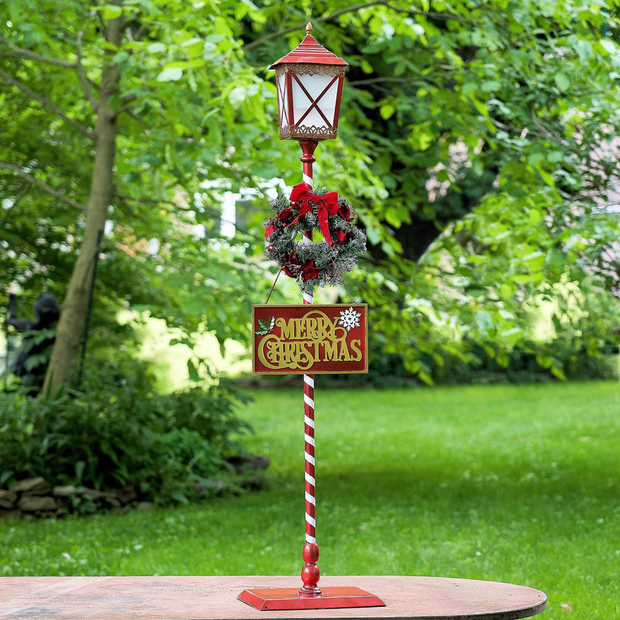 Standing iron Christmas lantern with LED lights and poinsettia wreath, product photo 1