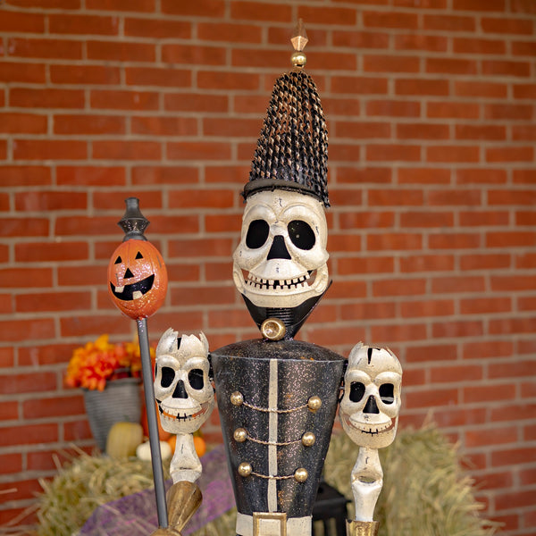 63.5 inch iron skeleton guard holding a pumpkin staff with skull adorned shoulders, distressed hand painted finish