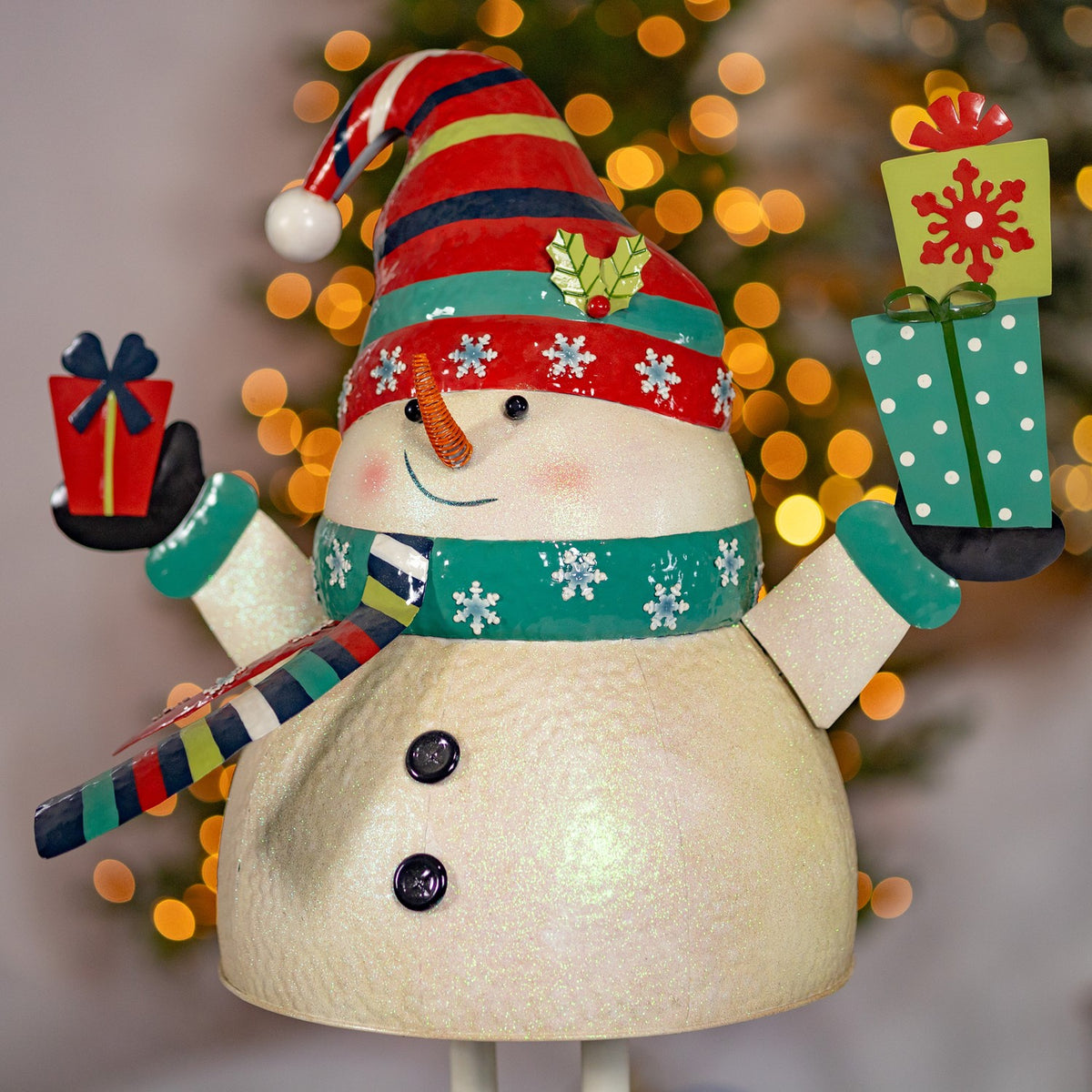 Iron snowman holding presents figurine, front view