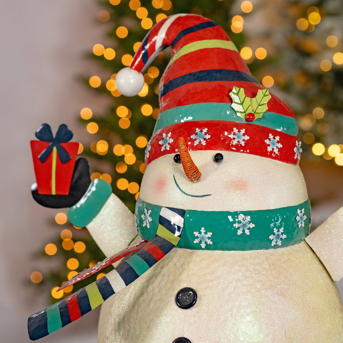 Iron snowman holding presents figurine product photo