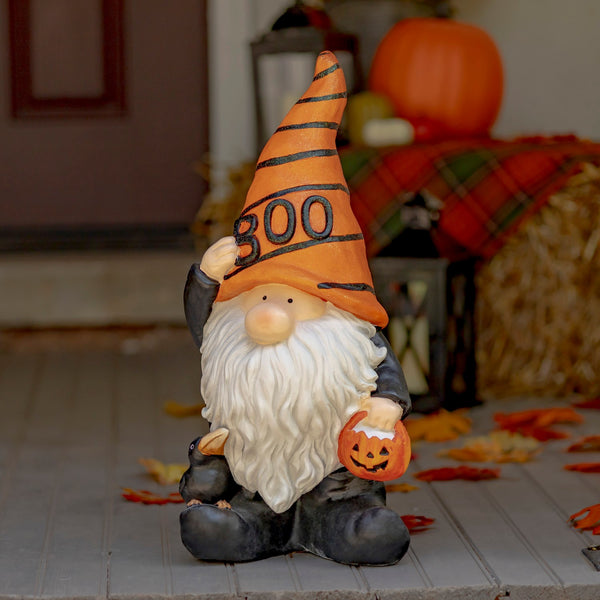 Hand painted Halloween garden gnome wizard in an orange BOO hat holding a pumpkin basket