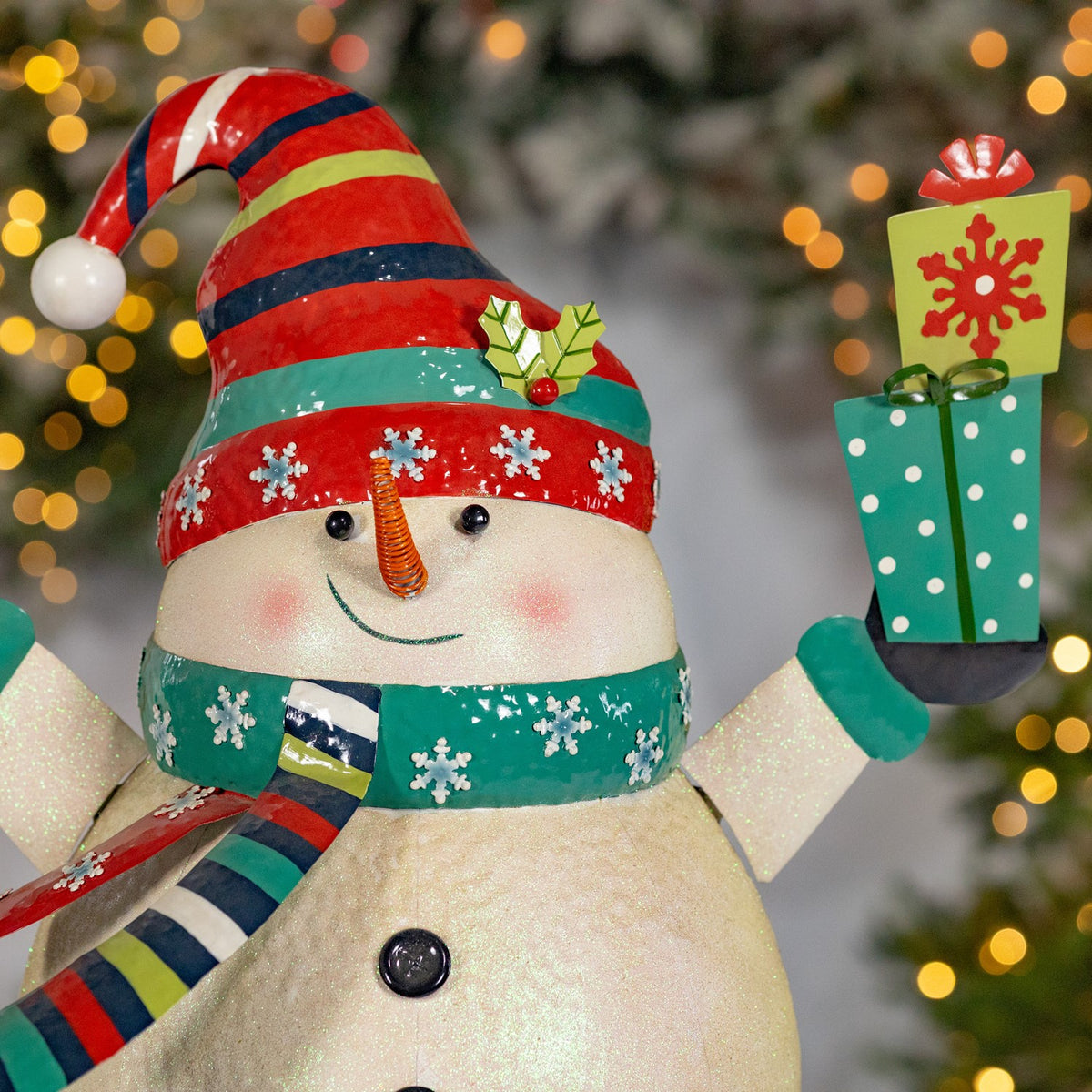 Iron snowman holding presents figurine product photo